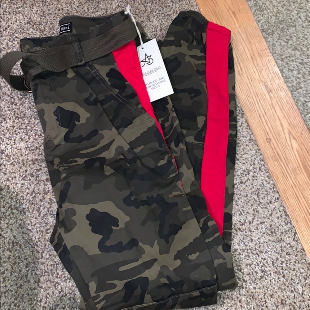 Camo cargo pants with a red stripe on the sides